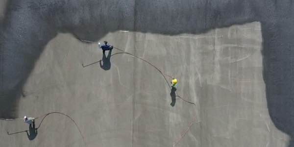 Stripe-It-Up crew apply sealcoat to a runway